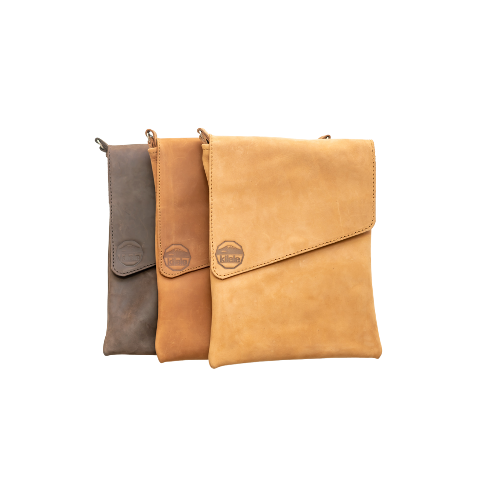 Three leather bags in brown, tan, and beige on a white background