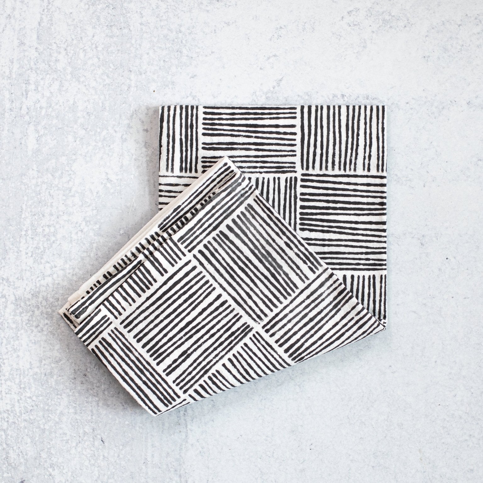 Two black and white patterned boxes on a light gray background