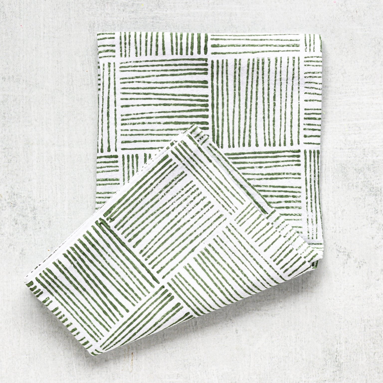 Folded fabric with geometric pattern on a light gray background