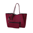 Red tote bag with black accents on a white background