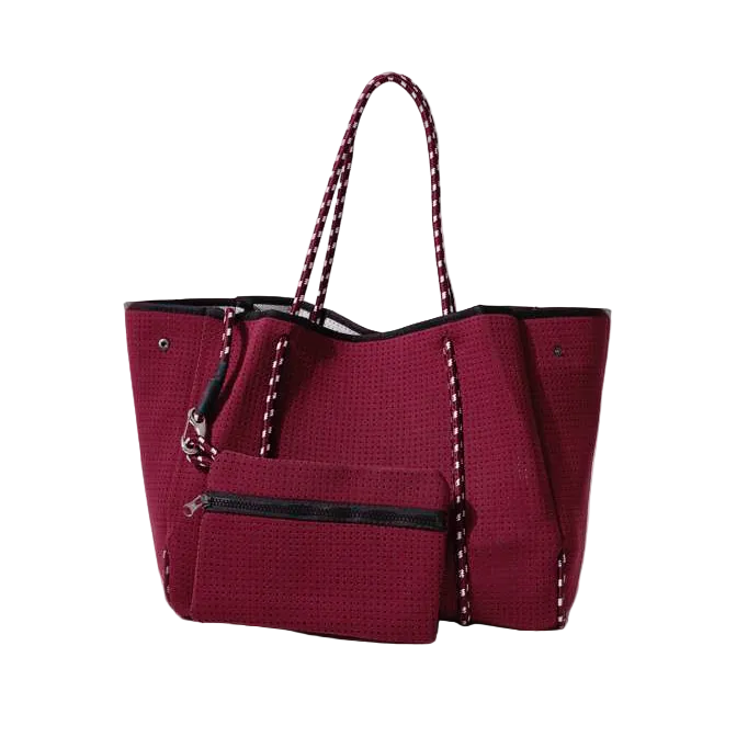 Red tote bag with black accents on a white background