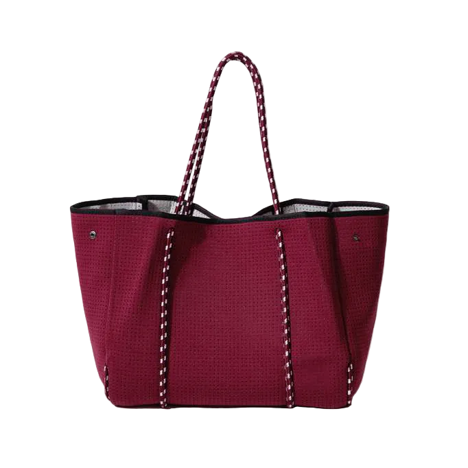 Red tote bag with black trim on a white background