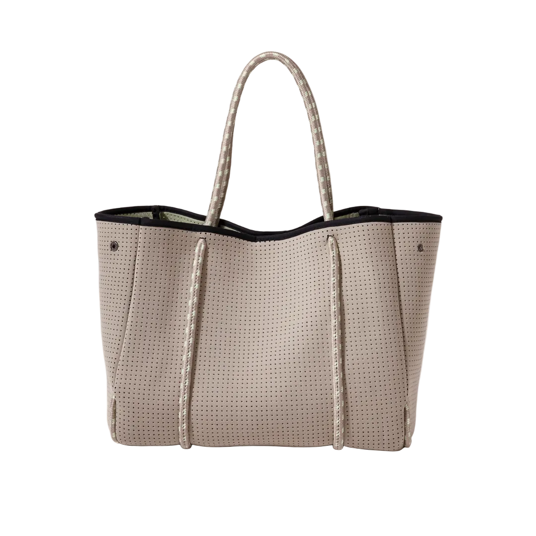 Beige woven handbag with black trim on a white background