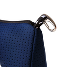 Close-up of a blue perforated bag with a metallic clasp on a light gray background