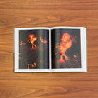 Open spread: two aerial photographs of glowing orange lava erupting across dark volcanic ground