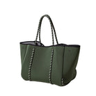 Green handbag with black interior on a white background