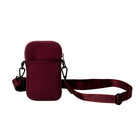 Maroon crossbody bag with a strap on a white background