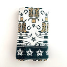 Folded towel with cowboy boot and star pattern on a white background