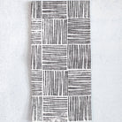 Black and white patterned towel on a light gray background