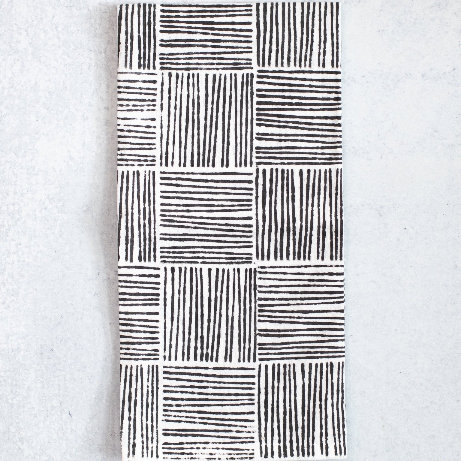 Black and white patterned towel on a light gray background