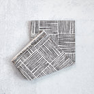 Two black and white patterned boxes on a light gray background