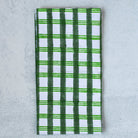 Green and white checkered towel on a gray surface