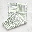 Folded fabric with geometric pattern on a light gray background